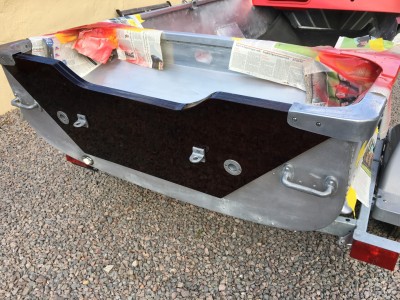 Outer transom with ski eyes, splashwell drain holes and transom caps mounted.