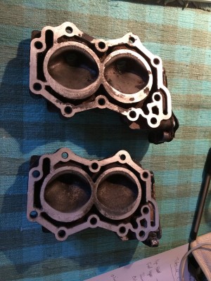 Both these 6hp cylinder heads were warped, but the lower head is now re-surfaced and the engine is running okay
