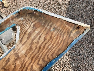 Upholstered side panels, showing rotted areas where fastenings were positioned.